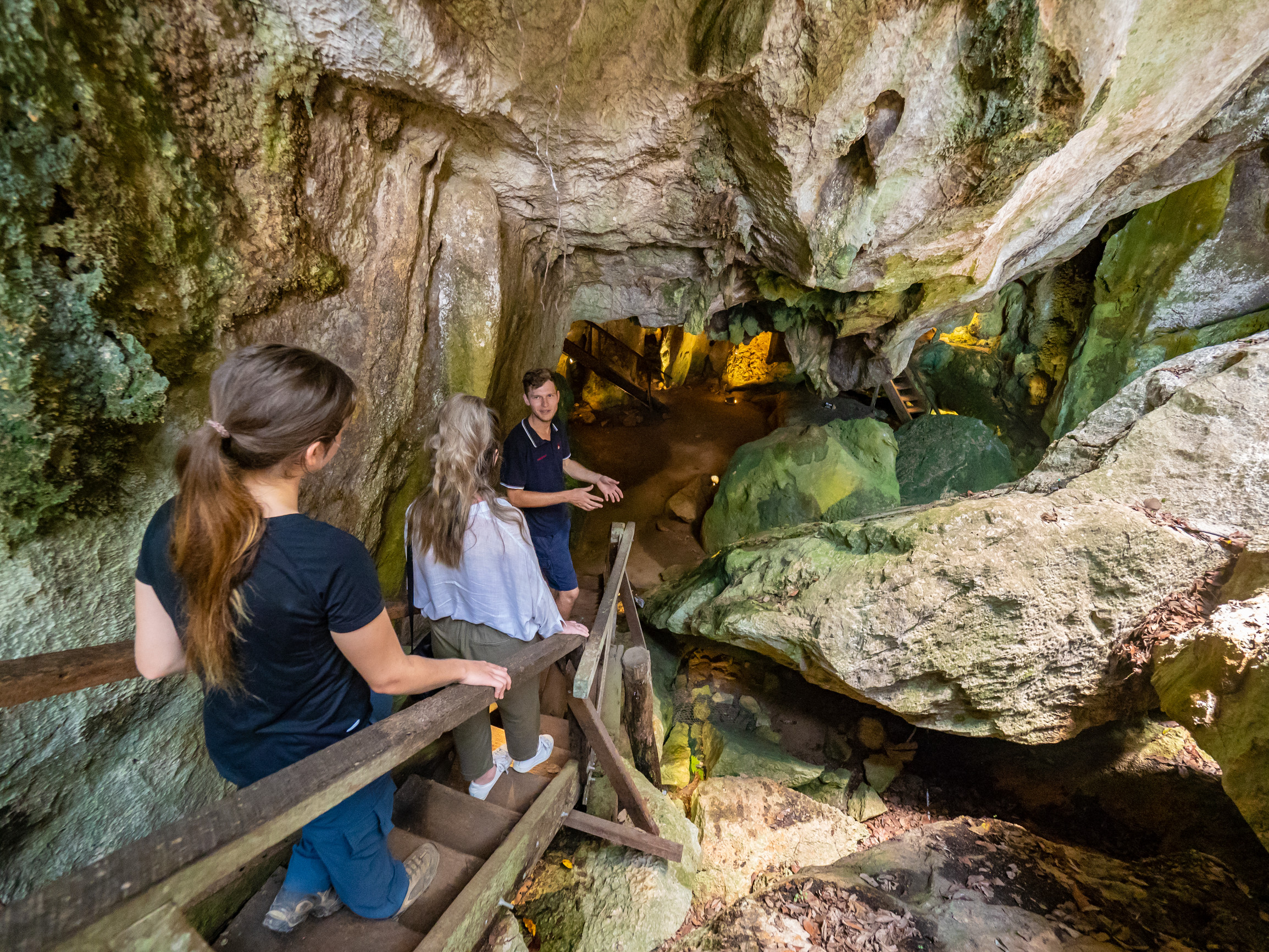 A tour group entering Capricorn Caves with a guide